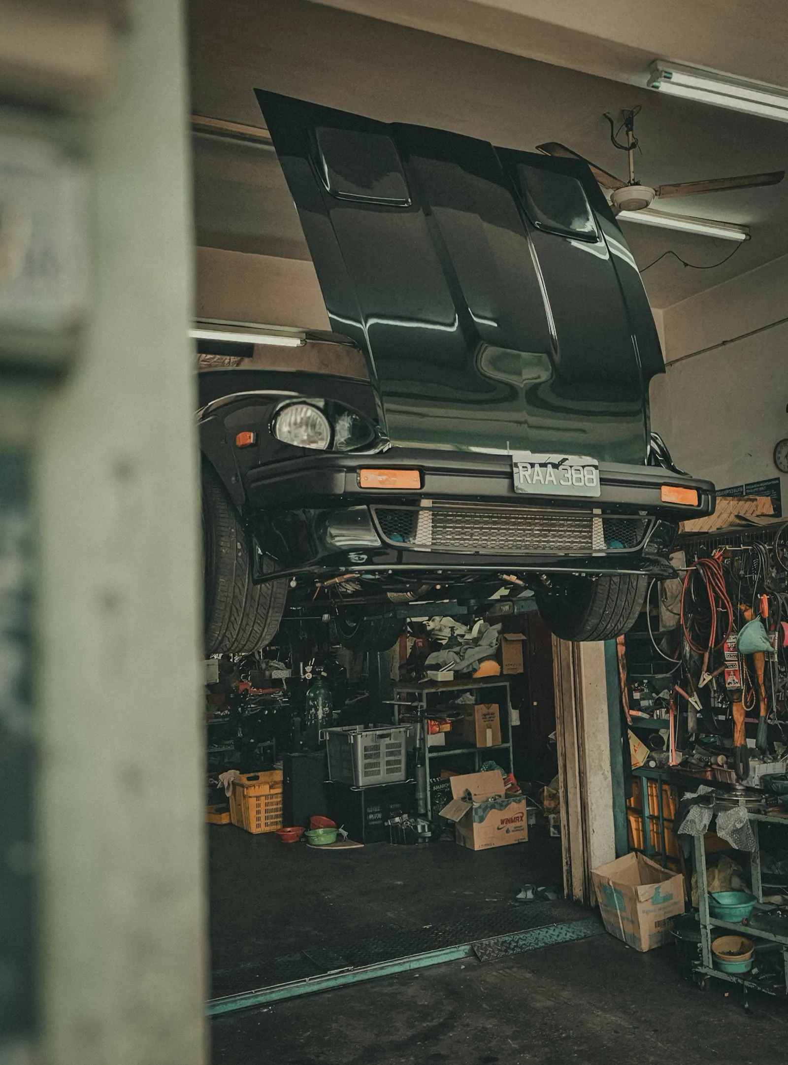 A car raised on a lift with the hood open