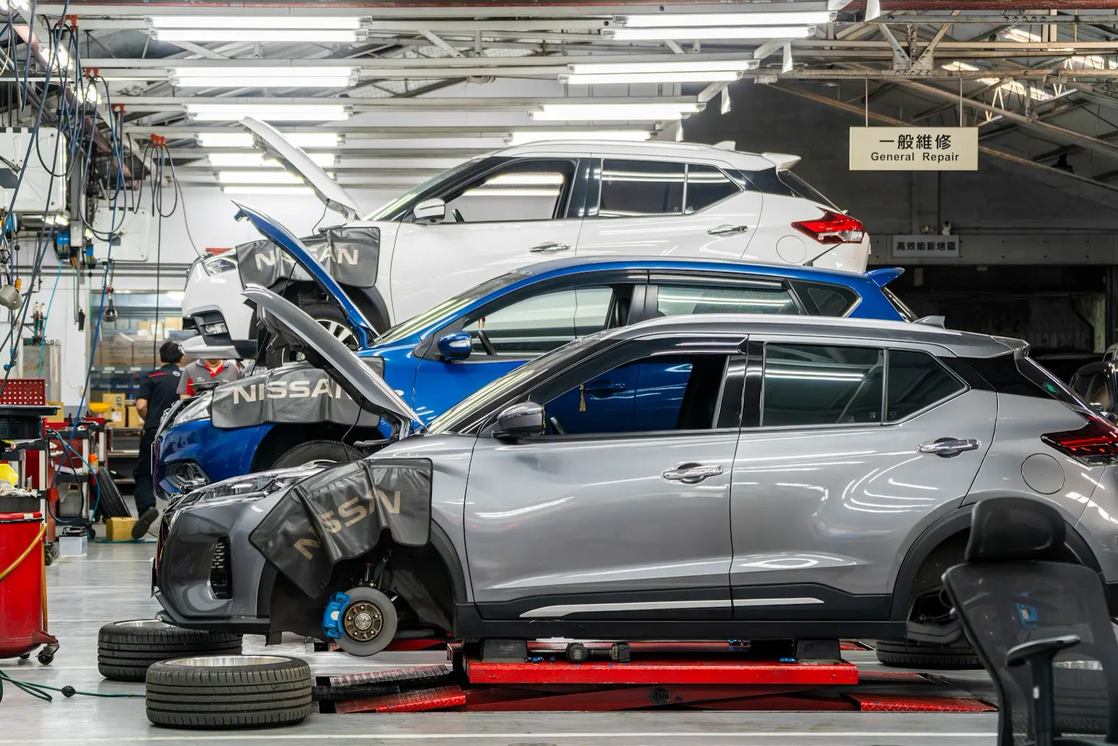 SUV on a lift with the wheels off for brake work