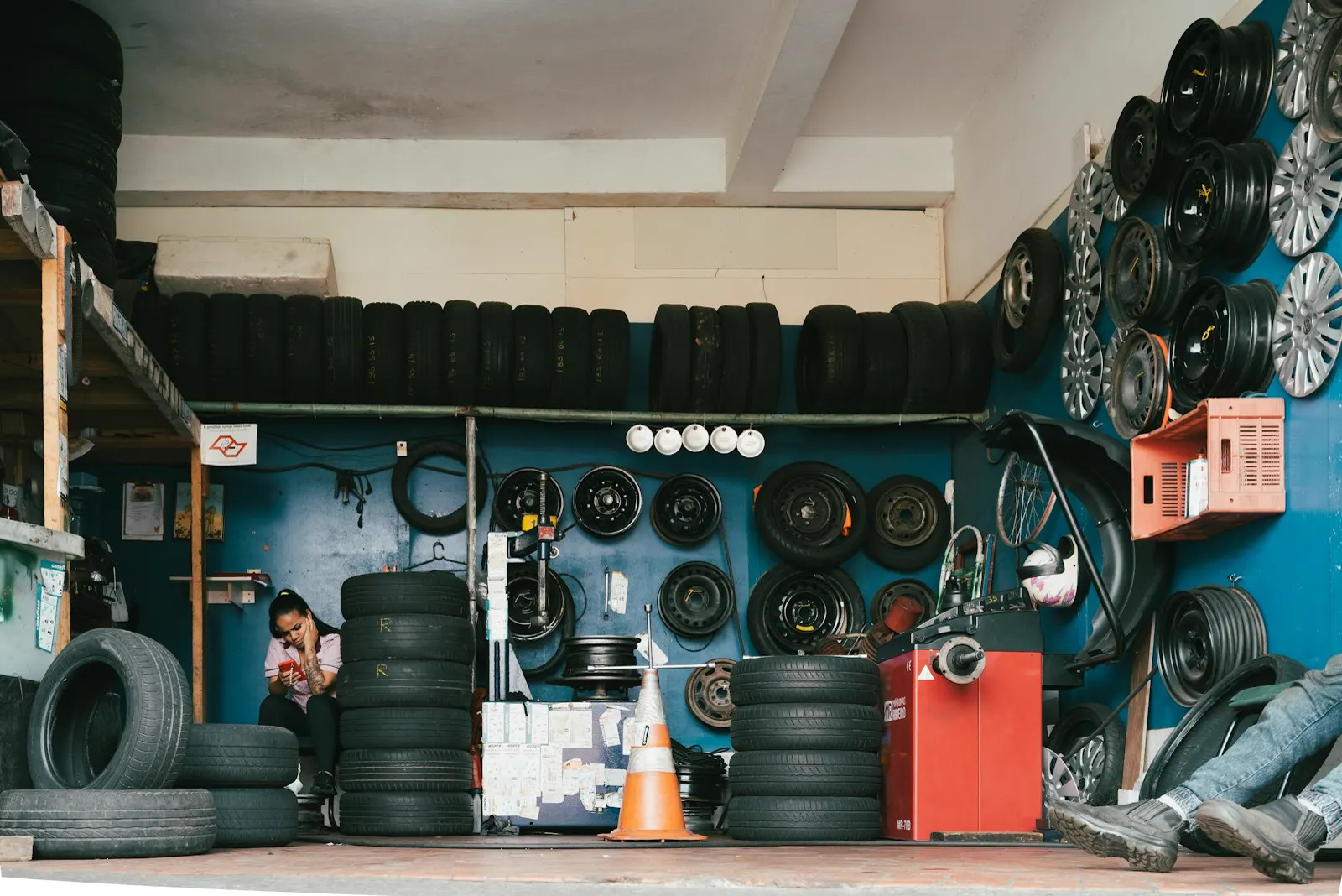Shelves of tires and wheels in a working garage